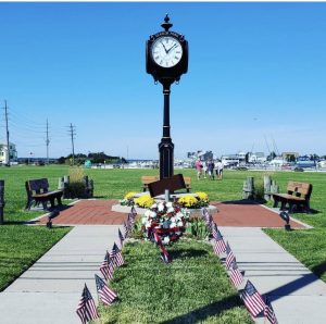 A clock stands in the center of a park